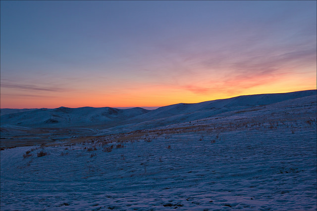 sunrise on the snowy steps of mongolia