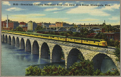 "Streamliner Crossing Mississippi River over Stone Arch Bridge, Minneapolis, Minn." / postcard