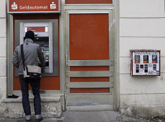 Man at ATM; Gumball Dispenser